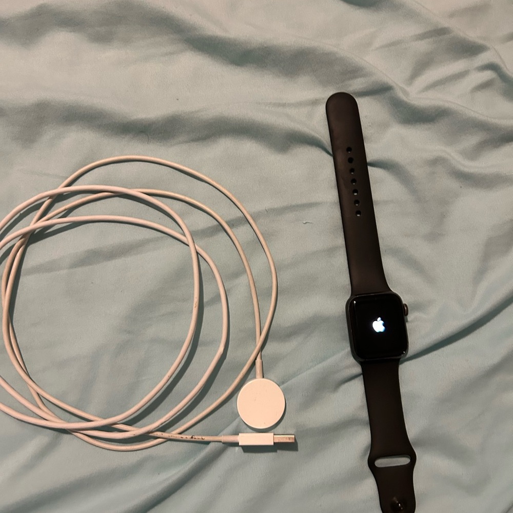 Apple Black Smartwatch with White Magnetic Charger Cable